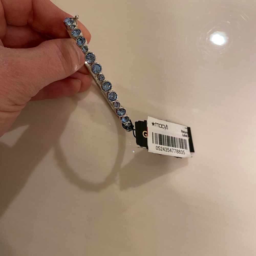 Silver bangle bracelet with blue stones